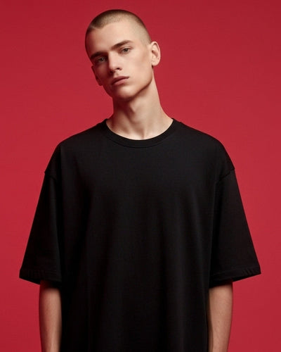 Person wearing a black t-shirt against a red background