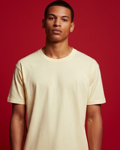 Man wearing a beige t-shirt against a red background