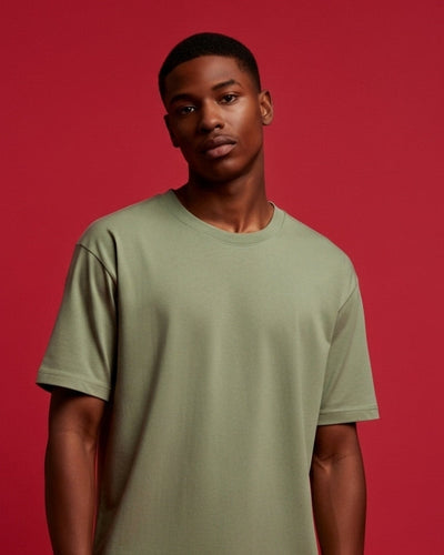 Man wearing a green t-shirt against a red background