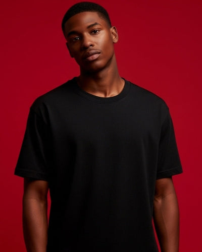 Man wearing a black t-shirt against a red background